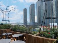 um pátio com mesas e cadeiras e vista para a cidade em The Bloom Pham Viet Chanh - Modern Living Space in Saigon - A Top Choice for Western Travelers em Cidade de Ho Chi Minh
