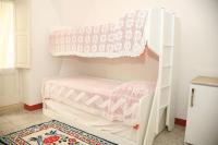 A bed or beds in a room at La Torre Antica Dimora