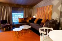 a living room with a couch and two tables at Original Sokos Hotel Vaakuna Rovaniemi in Rovaniemi