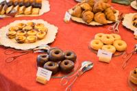 a table topped with plates of donuts and other pastries at Lam Hotel Convento do Desagravo in Oliveira do Hospital