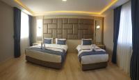 Postel nebo postele na pokoji v ubytování Martinenz Hotel