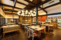 a restaurant with tables and chairs and a chandelier at Karuizawa Prince Hotel West in Karuizawa