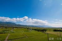 a large irrigated field with a bridge in the background at Fu Taitung Homestay in Taitung City