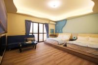 a large bedroom with two beds and a couch at Sweet Dream Homestay in Magong