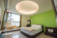 a bedroom with a bed and a large light fixture at Sweet Dream Homestay in Magong