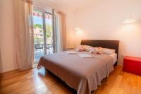 Postel nebo postele na pokoji v ubytování La Storia Apartments