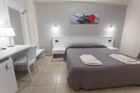 A bed or beds in a room at I Granai Messina