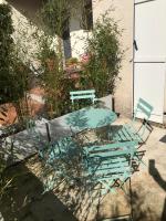 two chairs and a table and a table and chairs at Plan de Cuques T2 in Marseille