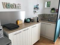 a kitchen with white cabinets and a sink at Plan de Cuques T2 in Marseille