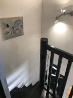 a staircase with a lamp and a painting on the wall at Plan de Cuques T2 in Marseille