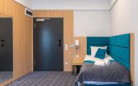 Posteľ alebo postele v izbe v ubytovaní Hotel Nad Czernicą