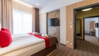 Posteľ alebo postele v izbe v ubytovaní Hotel Nad Czernicą