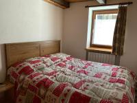 A bed or beds in a room at Casevacanza Val d'Ayas