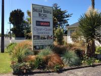 a sign for a buller bridge motel in a yard at Buller Bridge Motel in Westport