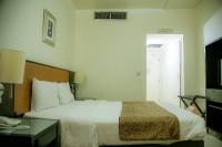 Postel nebo postele na pokoji v ubytování Phoenicia Grand Hotel