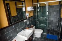 a bathroom with a sink and a toilet and a shower at Yong Guan in Yuchi