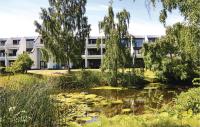 an apartment building with a pond in front of it at Stunning Apartment In Helsingr With Wifi in Helsingør