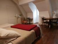 a bedroom with a bed and a table in a room at La Maison XVIIIe in Moulins