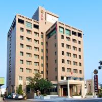 a tall building with a car parked in front of it at Jia Hsin Garden Hotel in Tainan