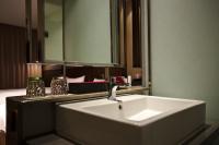a bathroom with a white sink and a mirror at In Sky Hotel in Taichung