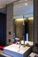 a bathroom with a sink and a large mirror at In Sky Hotel in Taichung