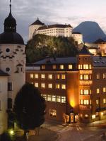 a group of buildings with a mountain in the background at Hotel Andreas Hofer in Kufstein