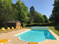 a swimming pool with chairs and a group at Manoir Du Parc (Adults only) in Amboise