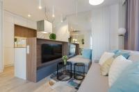 Televízia a/alebo spoločenská miestnosť v ubytovaní Apartament Różana