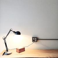 a desk with a lamp and a box on the floor at HomeStay LB in Taitung City