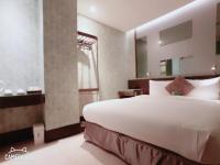 a bedroom with a large white bed and a window at Beauty Hotels Taipei - Hotel B7 in Taipei