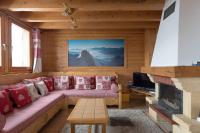 a living room with a couch and a fireplace at Chalet Le Lapye in Les Gets