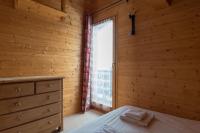 a bedroom with a bed and a window at Chalet Le Lapye in Les Gets