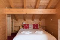 a bedroom with a bed in a wooden cabin at Chalet Le Lapye in Les Gets