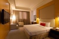 a hotel room with a bed with a red pillow at Ever Delightful Business Hotel in Chiayi City