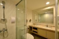 a bathroom with a shower and a toilet and a sink at Ever Delightful Business Hotel in Chiayi City