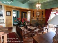 a living room with a table and chairs and a fireplace at TwoAngels in Knysna