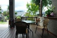 a patio with chairs and a table and a table and chairs at Hualien Sheraton Hostel in Hualien City