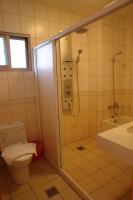 a bathroom with a shower and a toilet and a sink at Hualien Sheraton Hostel in Hualien City
