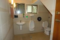 a bathroom with a toilet and a sink and a urinal at Hualien Sheraton Hostel in Hualien City