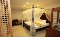 a bedroom with a bed with a canopy at Hualien Sheraton Hostel in Hualien City