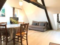 a living room with a table and a couch at Le Studio du Gouverneur in Honfleur