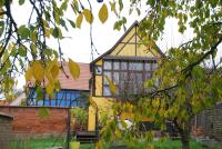 a yellow and blue building with a tree at maisonbleue67 in Kurtzenhouse