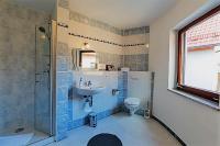 a bathroom with a sink and a shower and a toilet at Hotel Luca in Betzenstein
