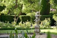 a statue of a girl on a fountain in a garden at Baumanière - Les Baux de Provence in Les Baux-de-Provence