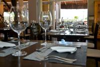 a table with wine glasses and silverware on it at Bahiamarela Boutique Hotel & SPA in Búzios