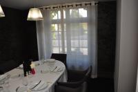 a table with a white table cloth and a window at Logis Hôtel A la Bonne Auberge in Laval