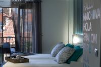 a bedroom with a bed and a large window at Salamanca Suite Studios in Salamanca