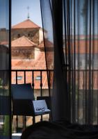a pair of glasses sitting on a chair in front of a window at Salamanca Suite Studios in Salamanca