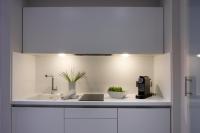 a white kitchen with a sink and a coffee maker at Salamanca Suite Studios in Salamanca