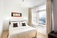 a bedroom with a large bed and a window at Hotel Villa Annette in Rabac